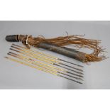 Six iron head arrows, 63cm, in leather covered quiver with leather tassles, 65cm