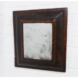 An antique oyster veneered and cushion fronted wall mirror with distressed rectangular glass