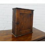 A small elm cupboard, the door with a star motif, opening to reveal a shelved interior, 37 x 43 x