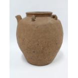 Southeast Asian unglazed earthenware pouring vessel with short spout and four loop handles, 33cm