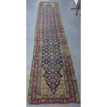 Persian runner, indigo field with flowerheads and multiple borders, a/f, 462 x 100cm