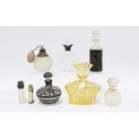 A collection of eight scent bottles to include a La Kristal amber moulded glass bottle and