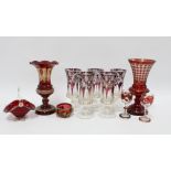A collection of cranberry and bohemian glassware to include vases, wine glasses and a small