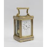Brass cased alarm carriage clock, striking on double gongs, 20cm high, including handle