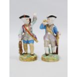 Two continental porcelain boy figures, both modelled standing wearing black tricorn hats, one