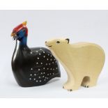 Holztiger wooden polar bear with blue painted eyes together with an African Carvers painted wood