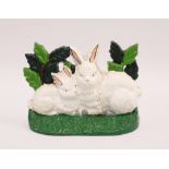 Painted cast iron doorstop with rabbits, 22cm long