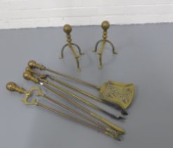 Pair of brass fire dogs and a brass fireside companion set. (6)