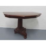 Mahogany side table, veneered eight sided top on a fluted column with platform base and bun feet,