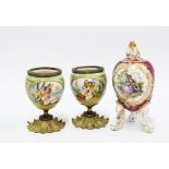 A pair of continental porcelain vases with classical figures and gilt metal bases together with a