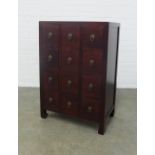 Chinese hardwood apothecary style cabinet, with twelve small drawers, 61 x 91 x 38cm.