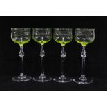 A set of four Uranium wine glasses, with delicately blown bowls on clear glass knop stems, (4) 18cm.