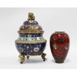 Cloisonne censer and cover and a small red lacquered cloisonné vase, (with area of damage) (2) 20cm.