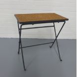 A contemporary folding table, wicker top on metal base, 56 x 57 x 33cm.