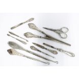 A collection of silver and white metal handled shoe horns, button hooks, glove stretchers, scissors,