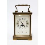 A brass repeating carriage clock by Matthew Norman of Switzerland, four glass panels, silvered