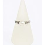 An Edwardian pearl and diamond ring, set in a platinum and white metal ring