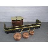A brass fender, copper coal bucket and three copper pans, (5)