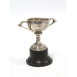 Small silver trophy cup, on ebonised plinth, circa early 20th century, 10cm high overall