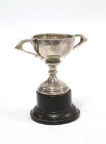 Small silver trophy cup, on ebonised plinth, circa early 20th century, 10cm high overall