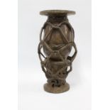 West African bronze vase of baluster form within an entwined ropework frame, 41cm high