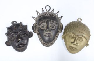 Three West African bronze wall masks, longest 23cm (3)