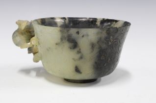 Chinese carved hardstone cup with a dragon handle, standing on a plain circular footrim, 12cm