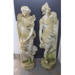 A pair of composite garden statues, modelled as standing male and female classical figures, with