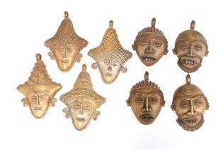 Four pairs of Nigerian bronze wall mask pendants, approx. 12cm long (8)