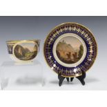 A Barr Worcester teacup and saucer, with topographical scenes against a blue ground and gilt