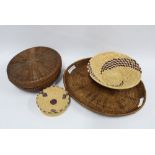 A woven tray, 47 x 48cm, together with three African woven baskets (4)