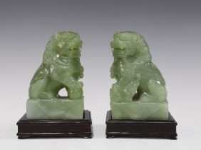 A pair of carved jadeite temple lions on wooden bases (2) 15 x 10cm.