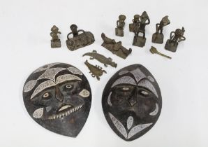 A pair of West African faux bronze wall masks and a group of ten miniature bronze animals and