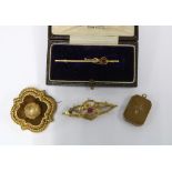 Two early 20th century 9ct gold brooches, 15ct gold locket and a yellow metal brooch with glazed