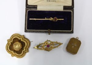 Two early 20th century 9ct gold brooches, 15ct gold locket and a yellow metal brooch with glazed