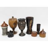 A collection of treen to include a lidded ebony pot, large covered cup, dressing table hat pin