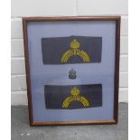 Showcase frame containing an ARP badge and two Civil Defence sleeve bands