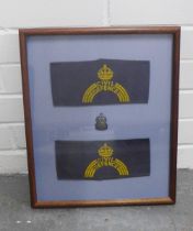 Showcase frame containing an ARP badge and two Civil Defence sleeve bands