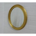 Circular gilt framed oval wall mirror, 39 x 48cm.