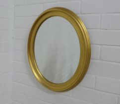 Circular gilt framed oval wall mirror, 39 x 48cm.