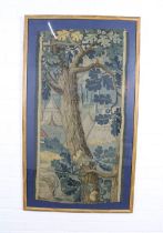 An Antique tapestry showing a camp in a forest, framed under glass, 112 x 60cm