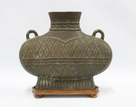 Large bronze archaic style vase with hatched pattern and loop handles, open base with shaped