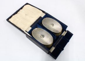 A pair of Gents silver backed brushes, cased, London 1945 (2)