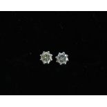 A pair of diamond stud earrings, mounted in unmarked white metal, approx 0.20ct