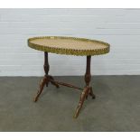 Brass mounted mahogany table with an oval red hardstone top with brass gallery, 75 x 56 x 47cm.