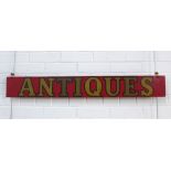 Handpainted red gilt 'Antiques' sign, 105 x 14cm.