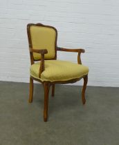 Fruitwood open armchair with yellow upholstered seat and back, on foliate carved cabriole legs, 64 x