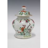 Qing Dynasty famille rose vase and cover, painted with peonies and foliage, (chip to outside rim