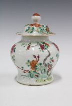 Qing Dynasty famille rose vase and cover, painted with peonies and foliage, (chip to outside rim