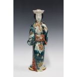 Kutani figure of a Bijin, Meiji period, modelled standing holding a double gourd, 37cm high